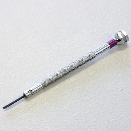 A precision screwdriver with a textured silver metal handle and a purple accent ring, shown diagonally on a light textured background.