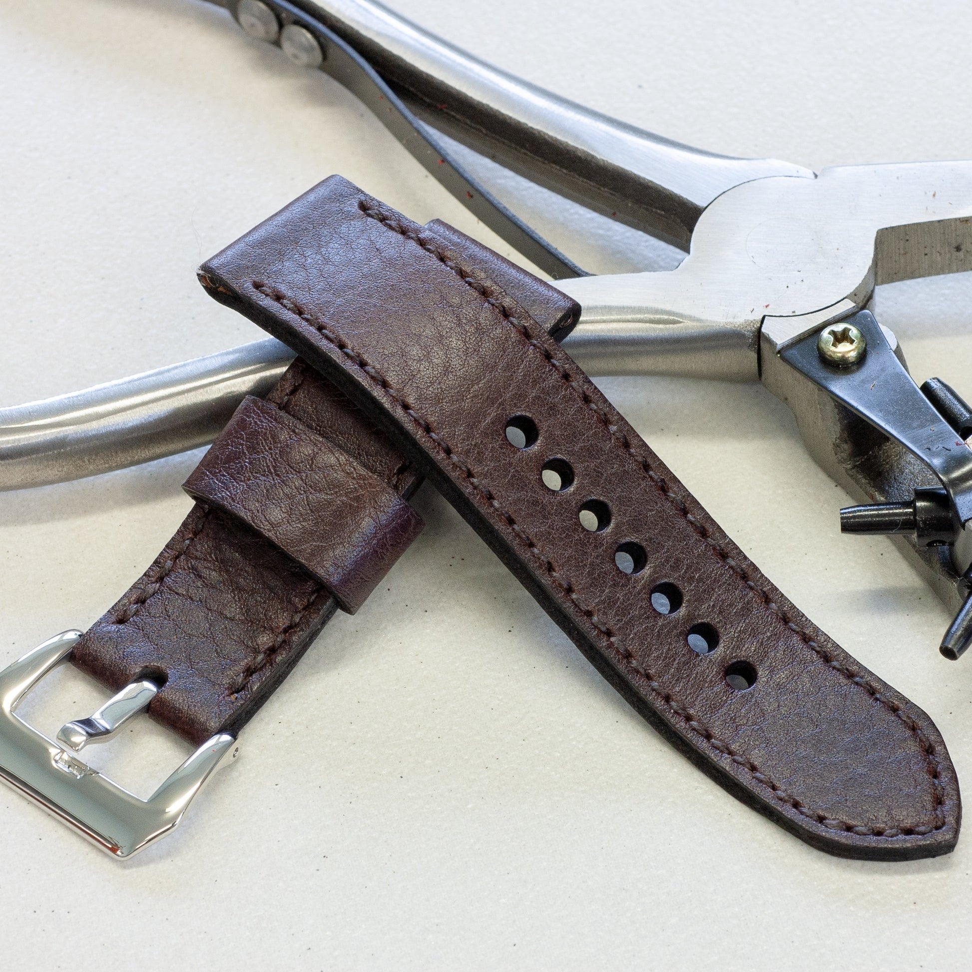 Aegir leather watch strap with dark brown stitching and polished steel buckle