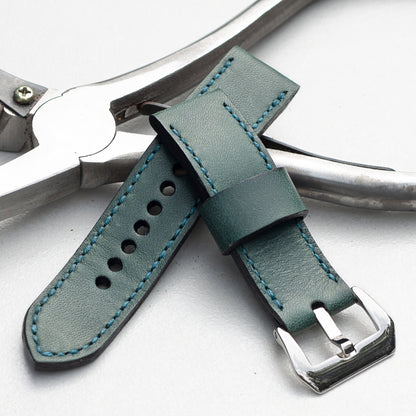 Aqua leather watch strap with teal stitching and polished steel buckle