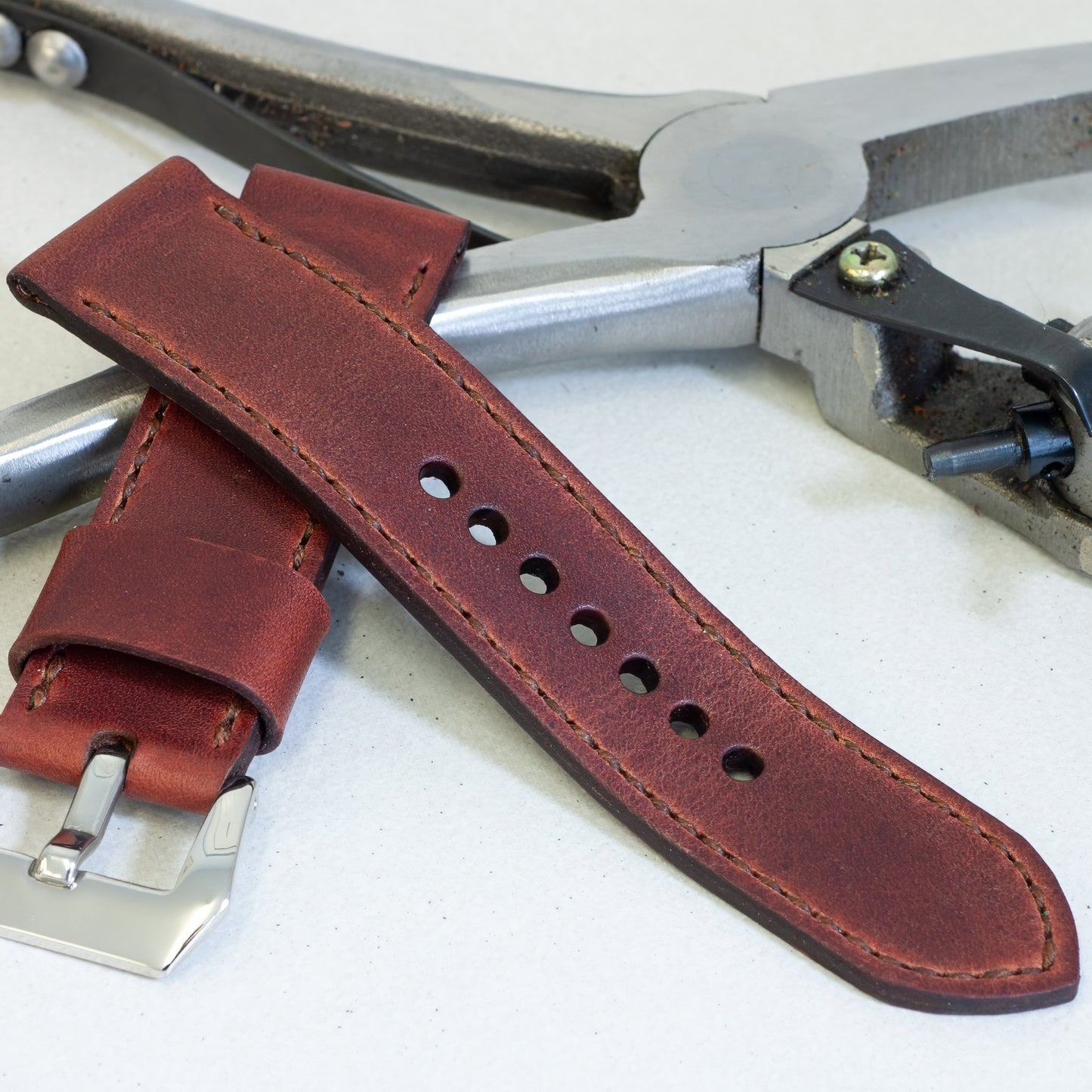 Autumn Leaf leather watch strap with light brown stitching and polished steel buckle
