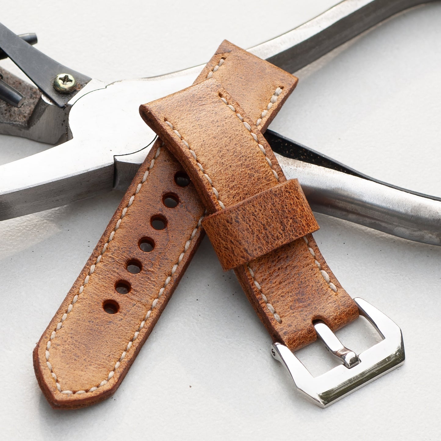 Bruiser leather watch strap with natural stitching and polished steel buckle