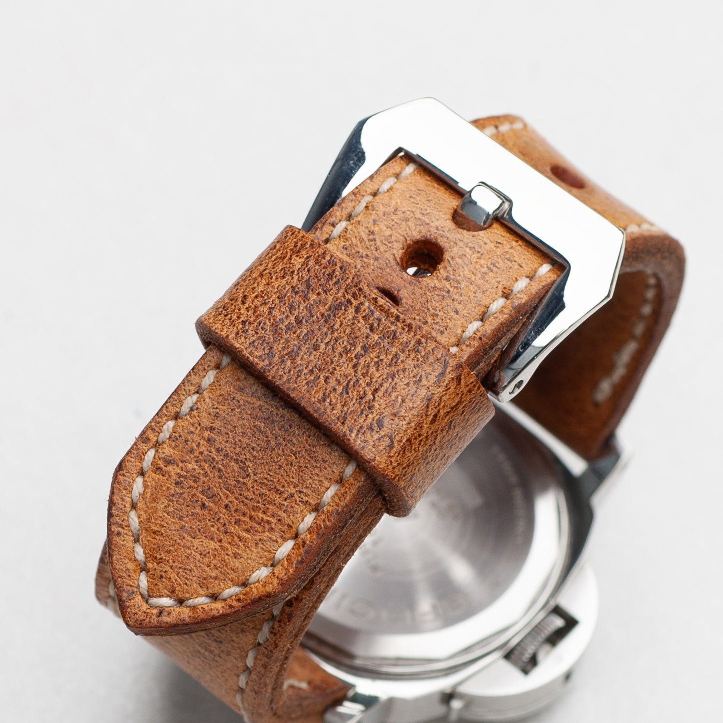 Bruiser leather watch strap with natural stitching and polished steel buckle