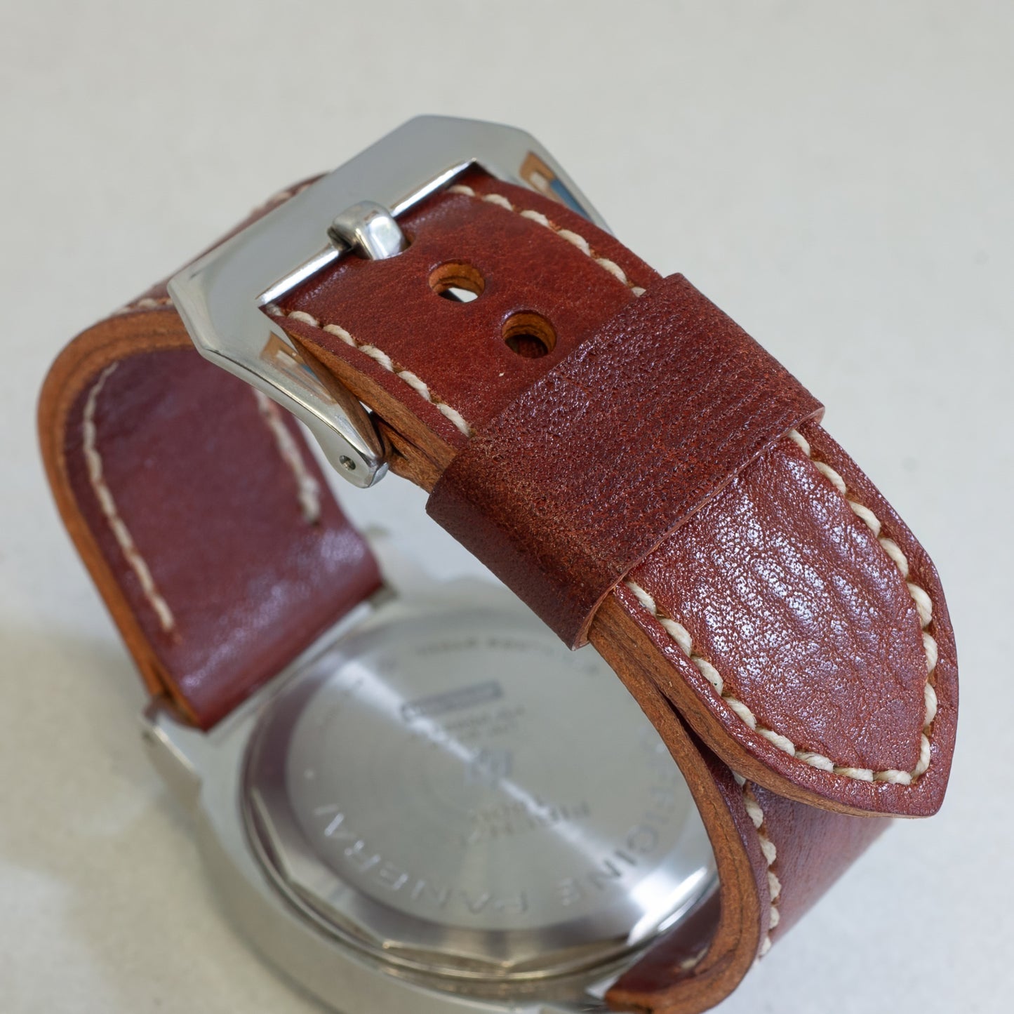 Burnt Sienna leather watch strap with natural stitching and polished steel buckle