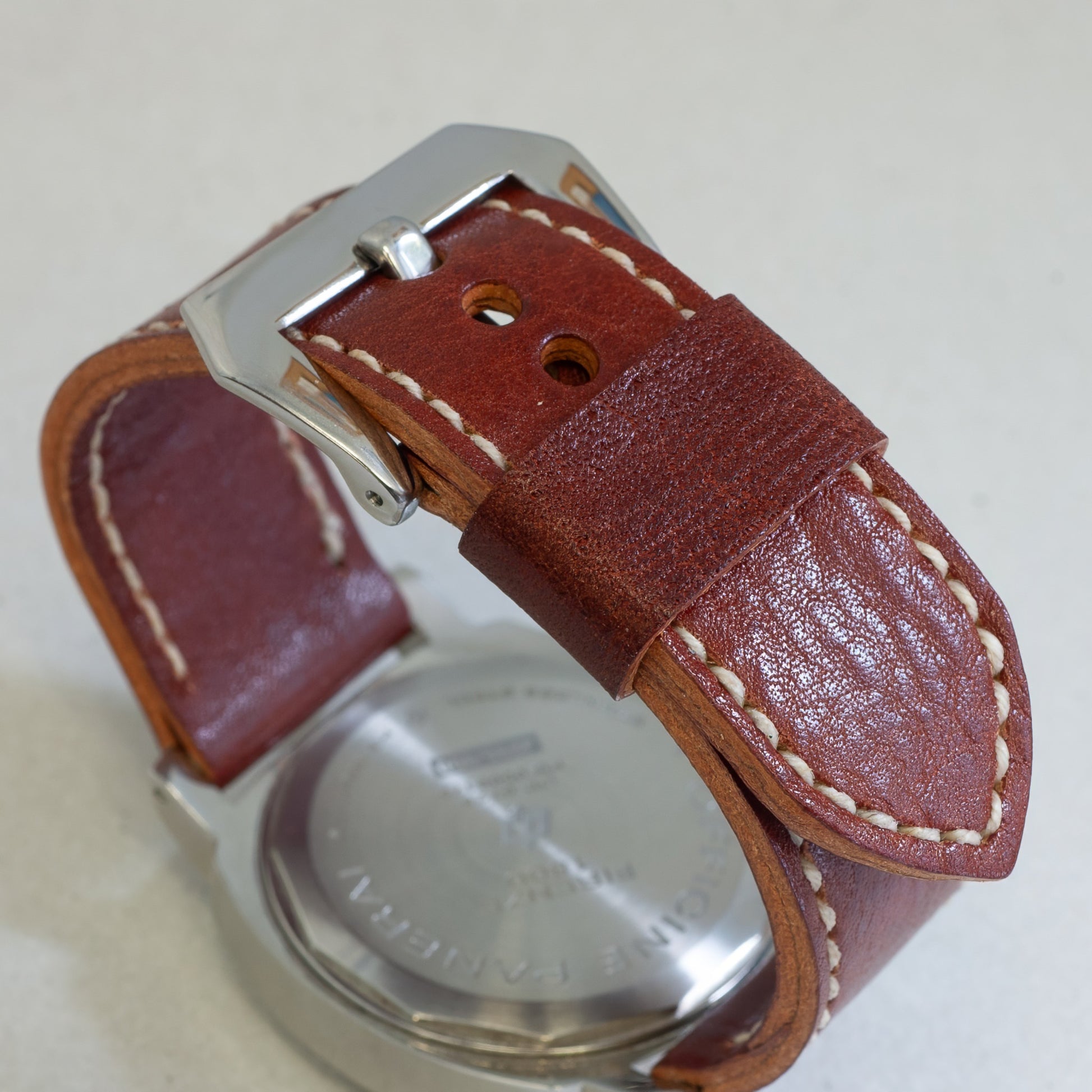 Burnt Sienna leather watch strap with natural stitching and polished steel buckle