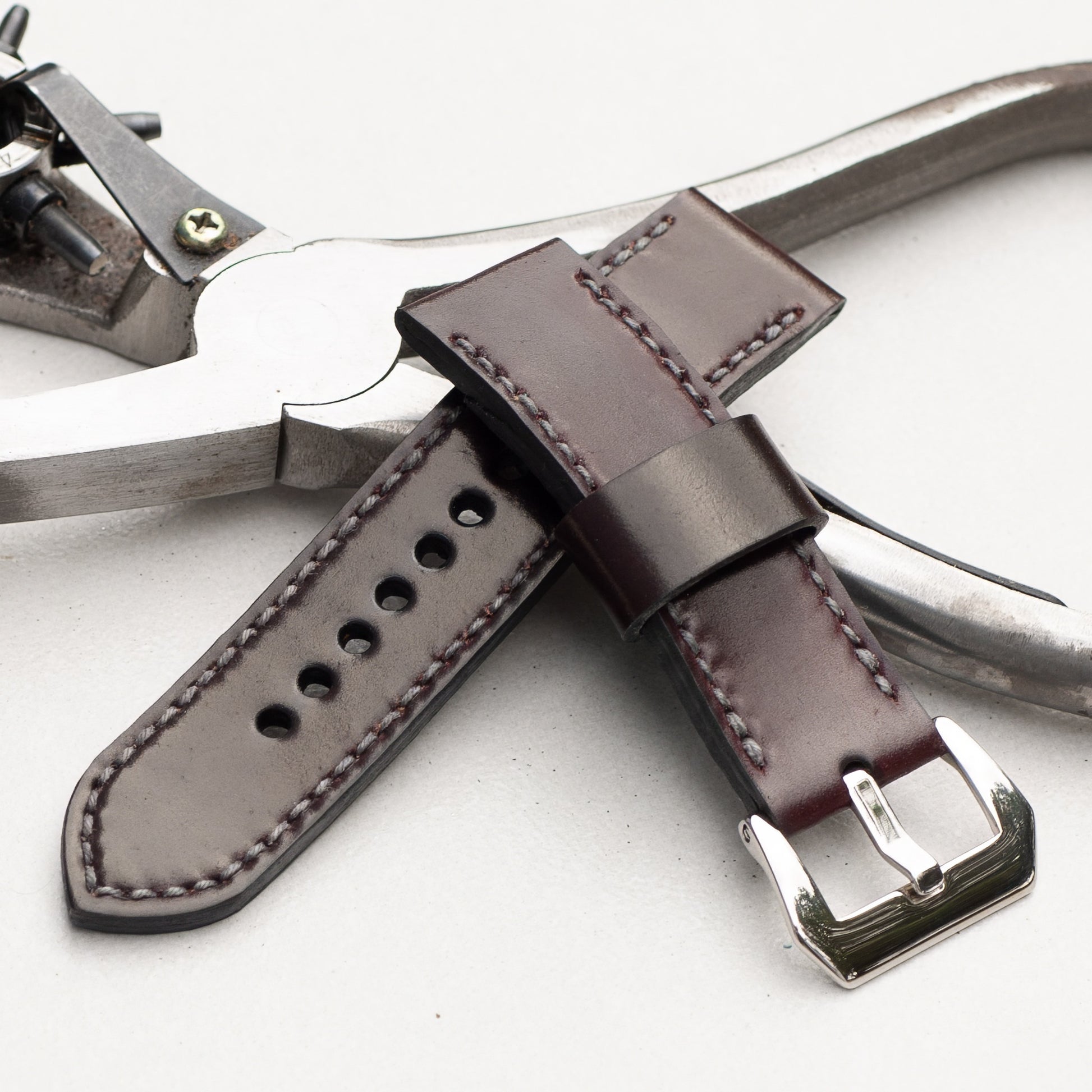 Burgundy Shell Cordovan leather watch strap with grey stitching and polished steel buckle