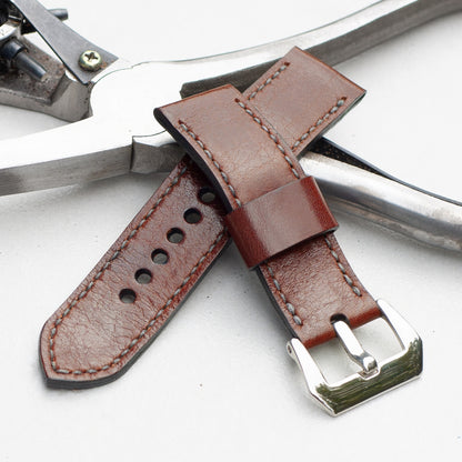 Chestnut leather watch strap with grey stitching and polished steel buckle