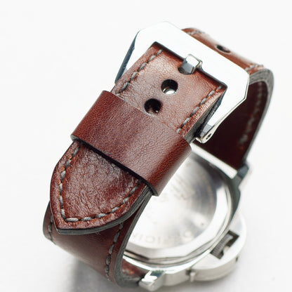 Chestnut leather watch strap with grey stitching and polished steel buckle
