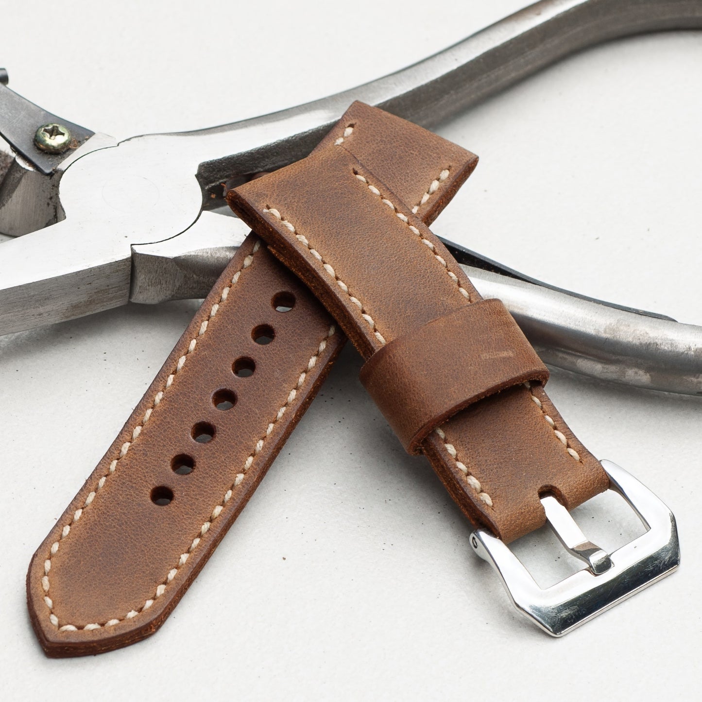 Cocoa leather watch strap with natural stitching and polished steel buckle