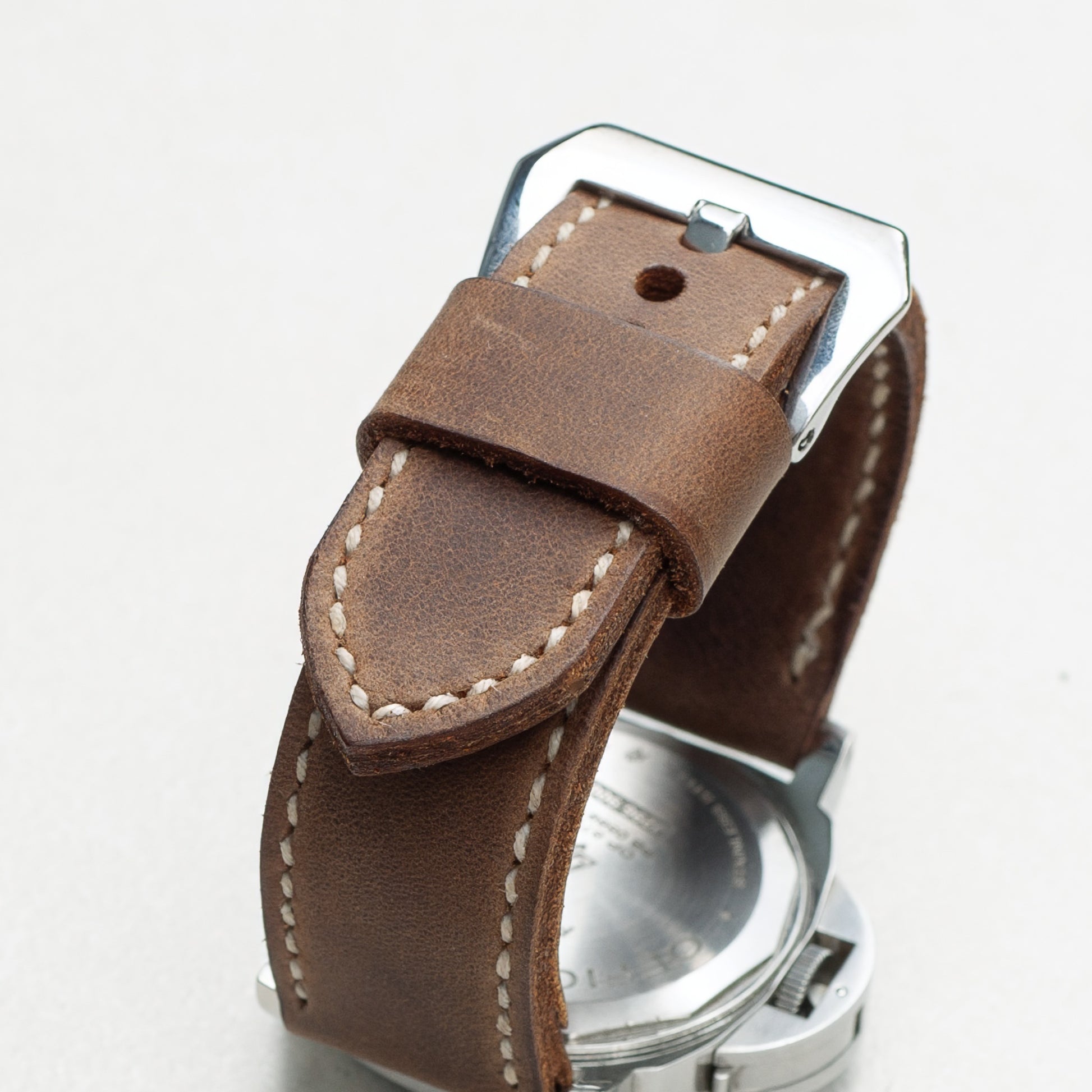 Cocoa leather watch strap with natural stitching and polished steel buckle