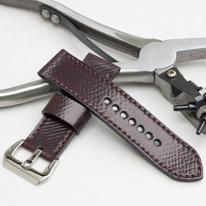 Cognac leather watch strap with dark brown stitching and polished steel buckle