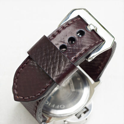 Cognac leather watch strap with dark brown stitching and polished steel buckle