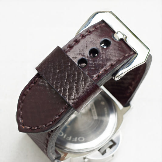 Cognac leather watch strap with dark brown stitching and polished steel buckle