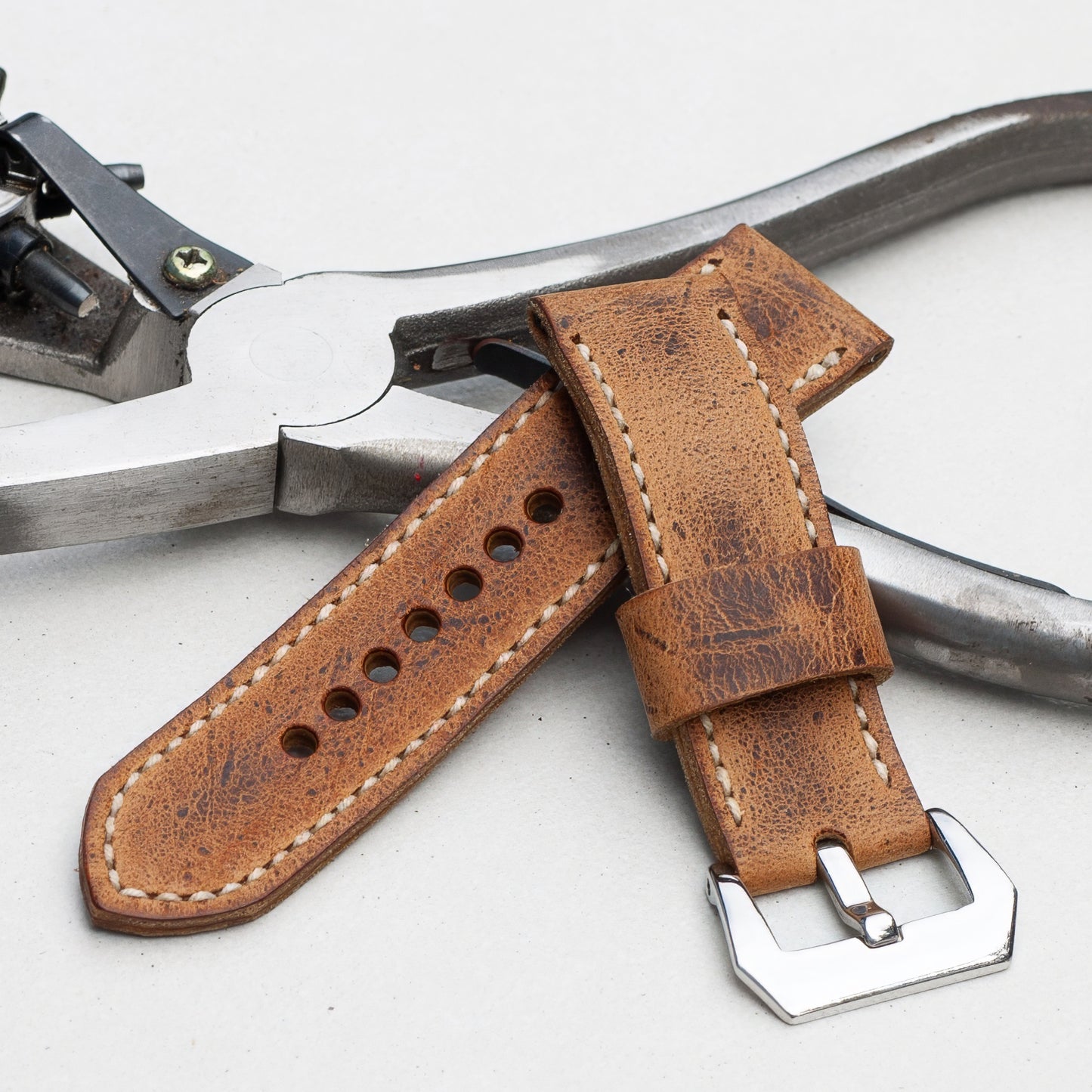 Dark Kudu leather watch strap with natural stitching and polished steel buckle