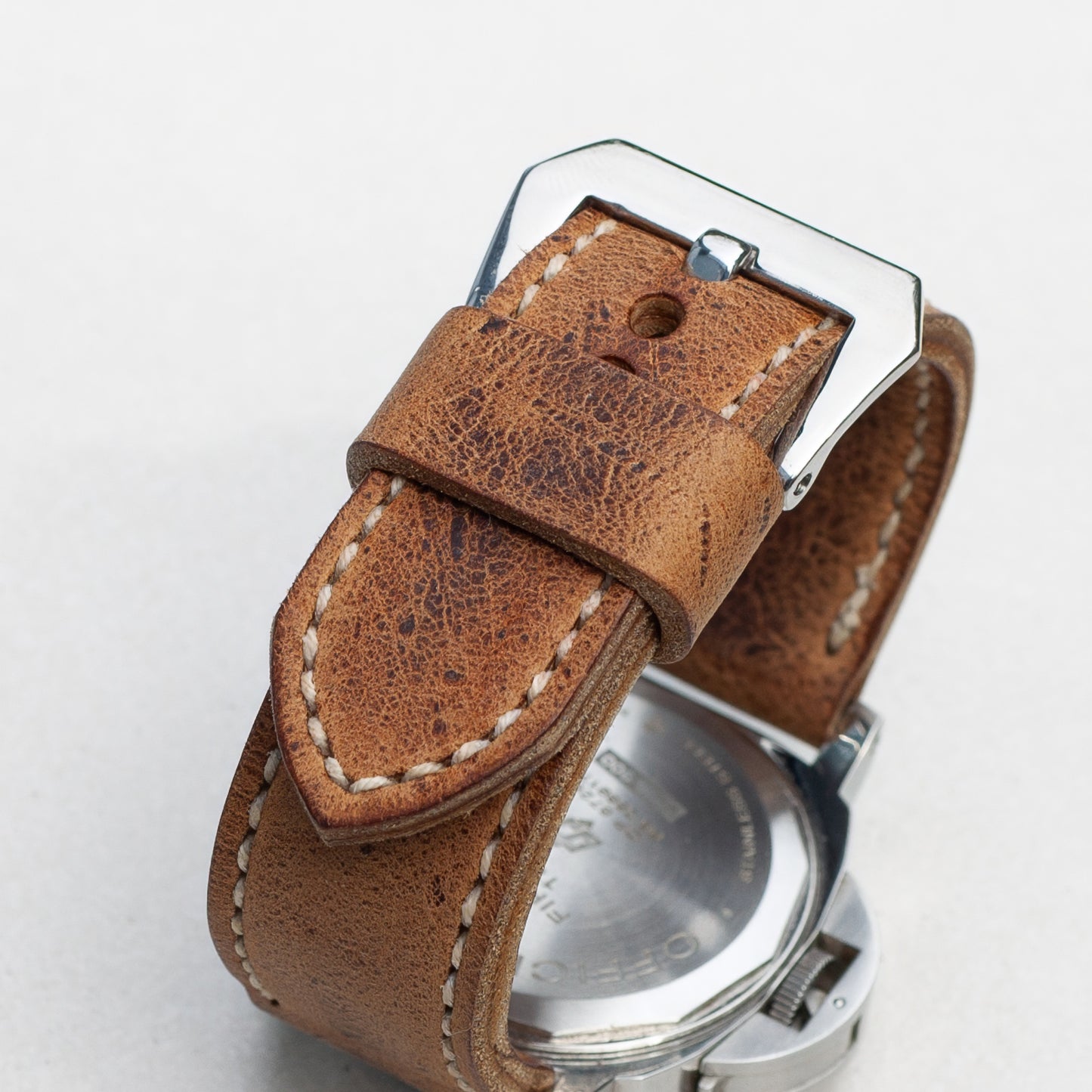 Dark Kudu leather watch strap with natural stitching and polished steel buckle
