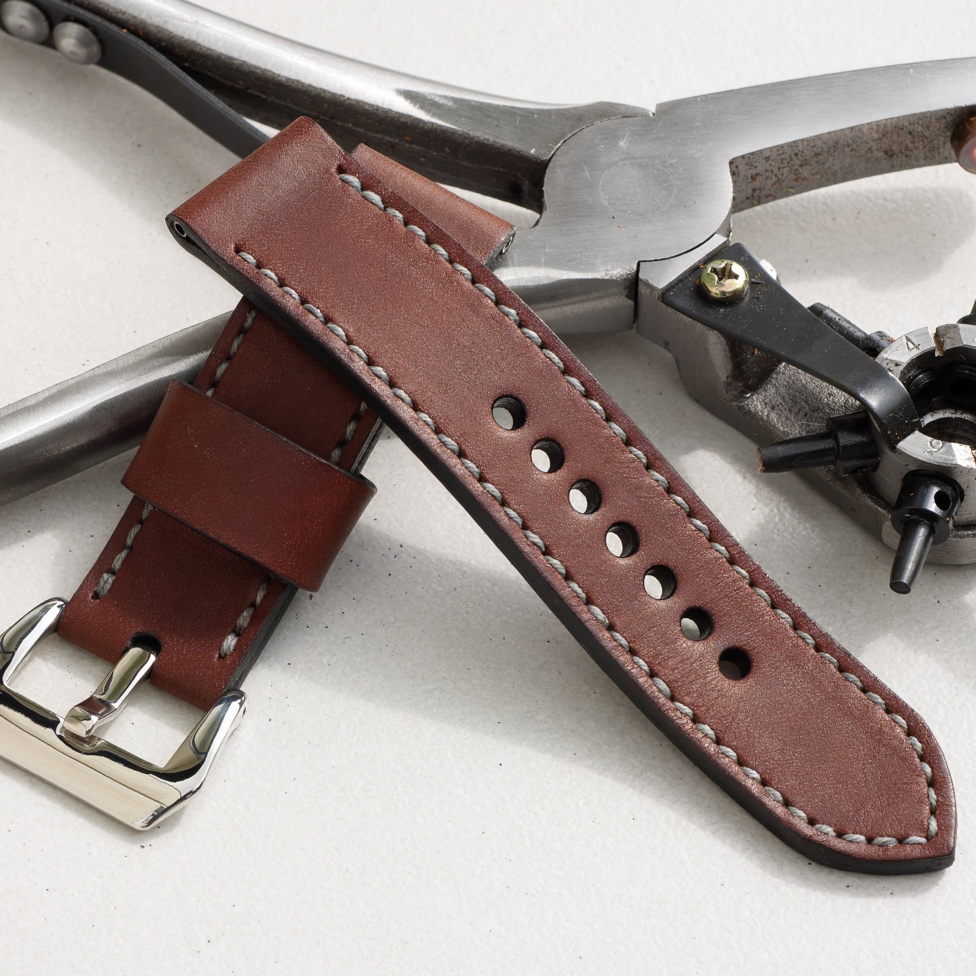 Espresso leather watch strap with grey stitching and polished steel buckle