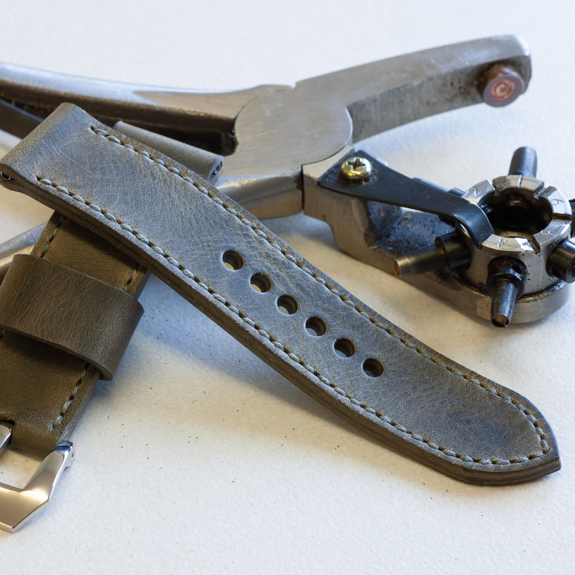 Gunpowder leather watch strap with grey stitching and polished steel buckle