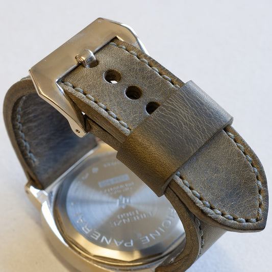 Gunpowder leather watch strap with grey stitching and polished steel buckle