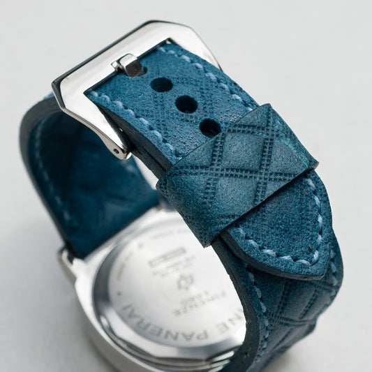 Harlequin leather watch strap with pale  blue stitching and polished steel buckle
