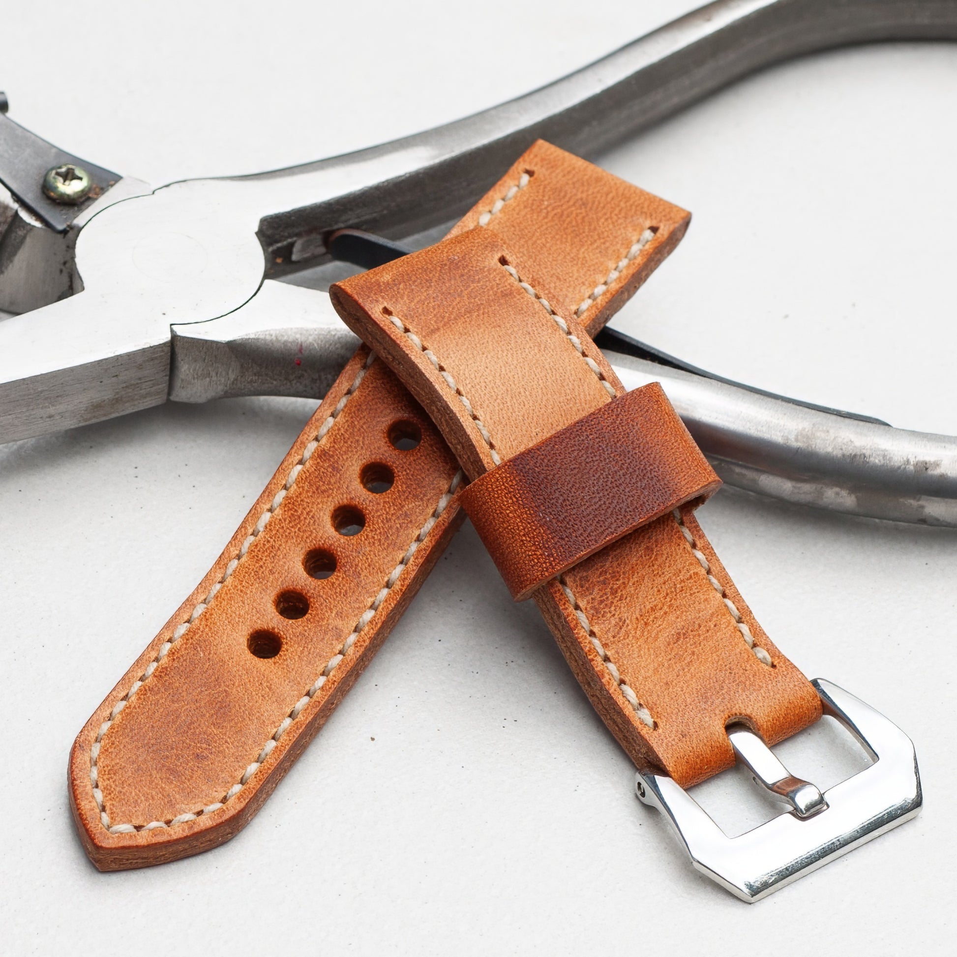 Horween Derby leather watch strap with natural stitching and polished steel buckle