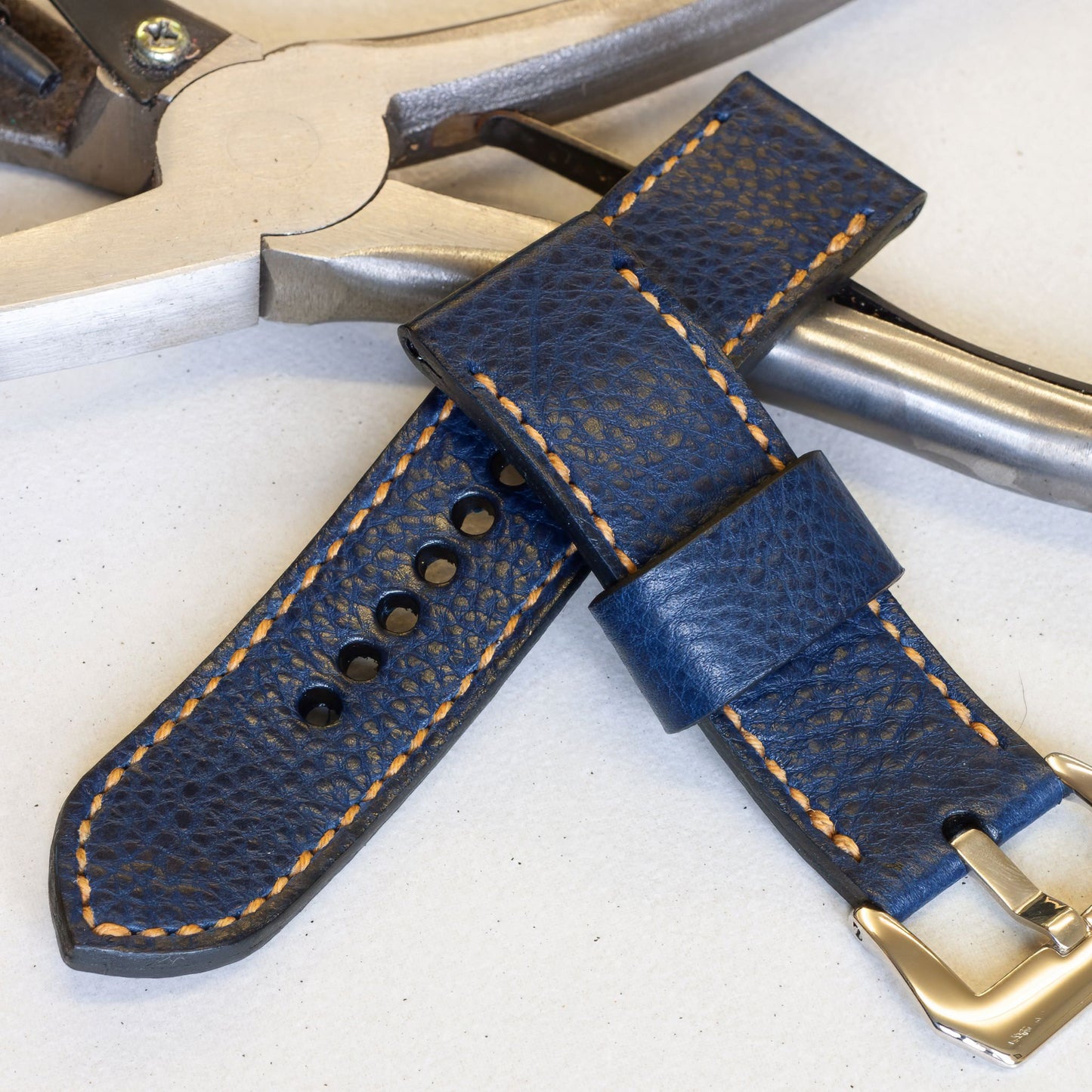 Indigo leather watch strap with butterscotch stitching and polished steel buckle