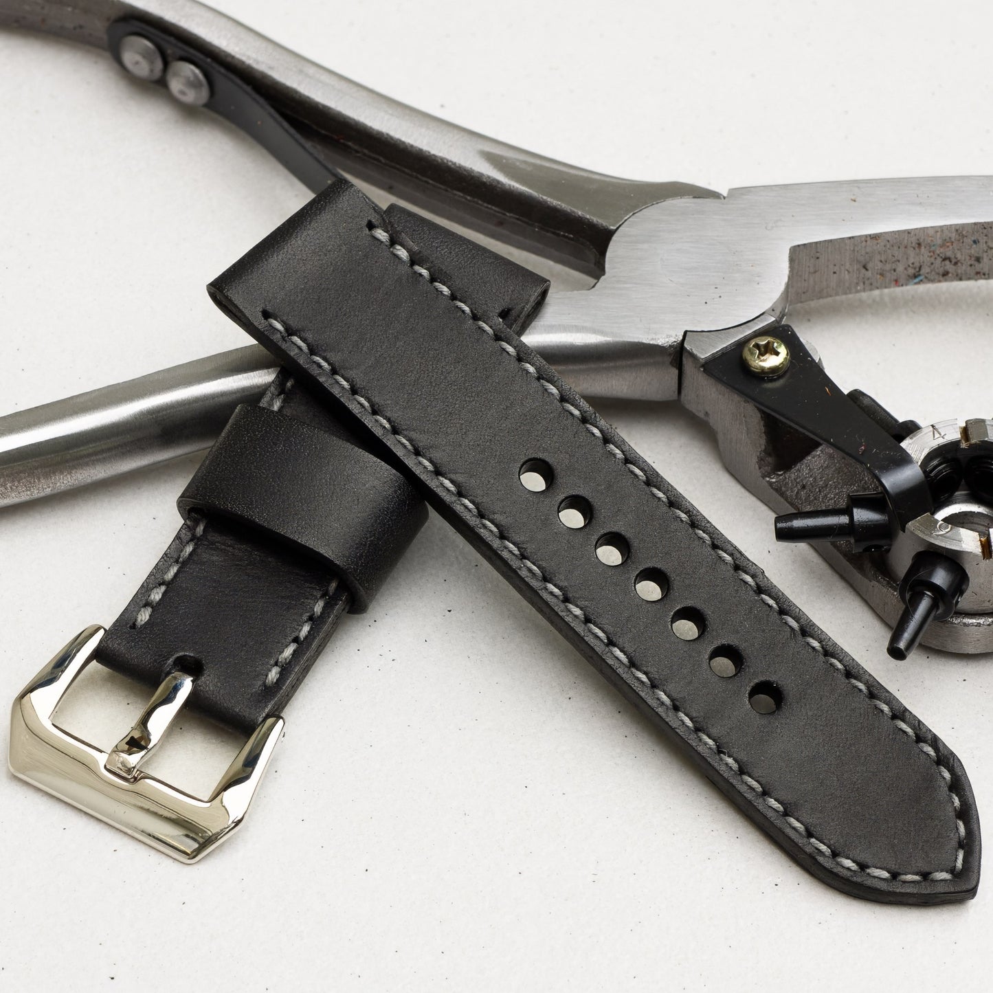 Nautilus leather watch strap with grey stitching and polished steel buckle