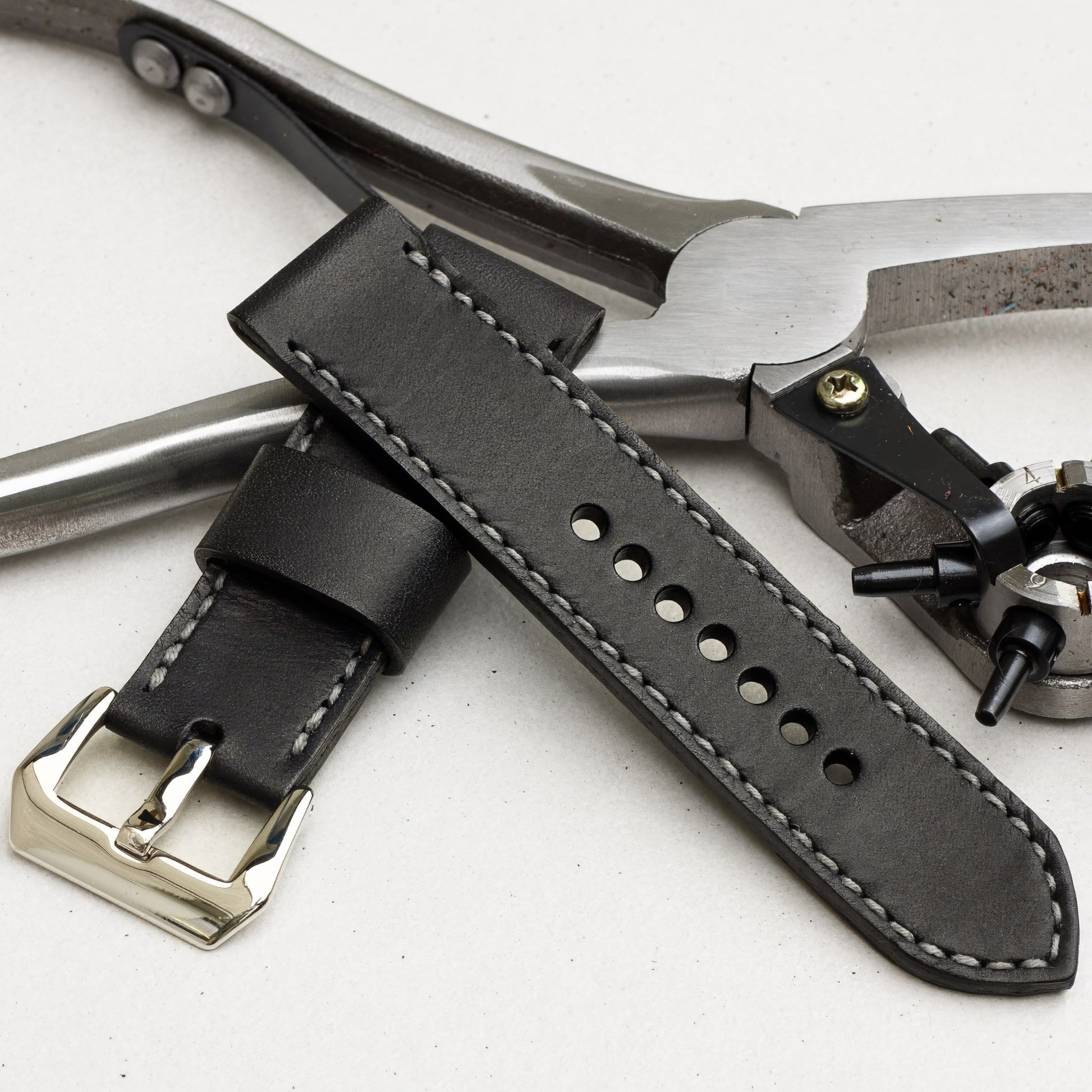 Nautilus leather watch strap with grey stitching and polished steel buckle