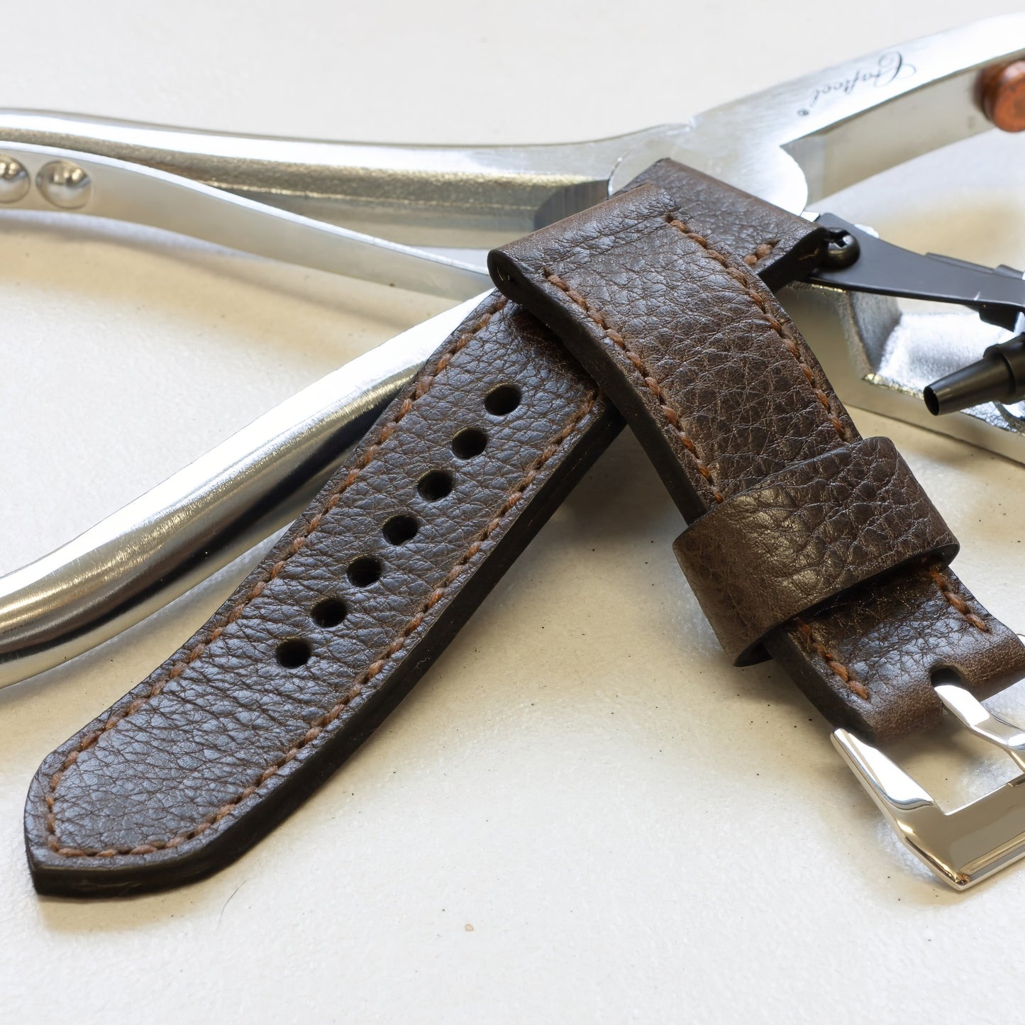 Nordic Ox leather watch strap with light brown stitching and polished steel buckle
