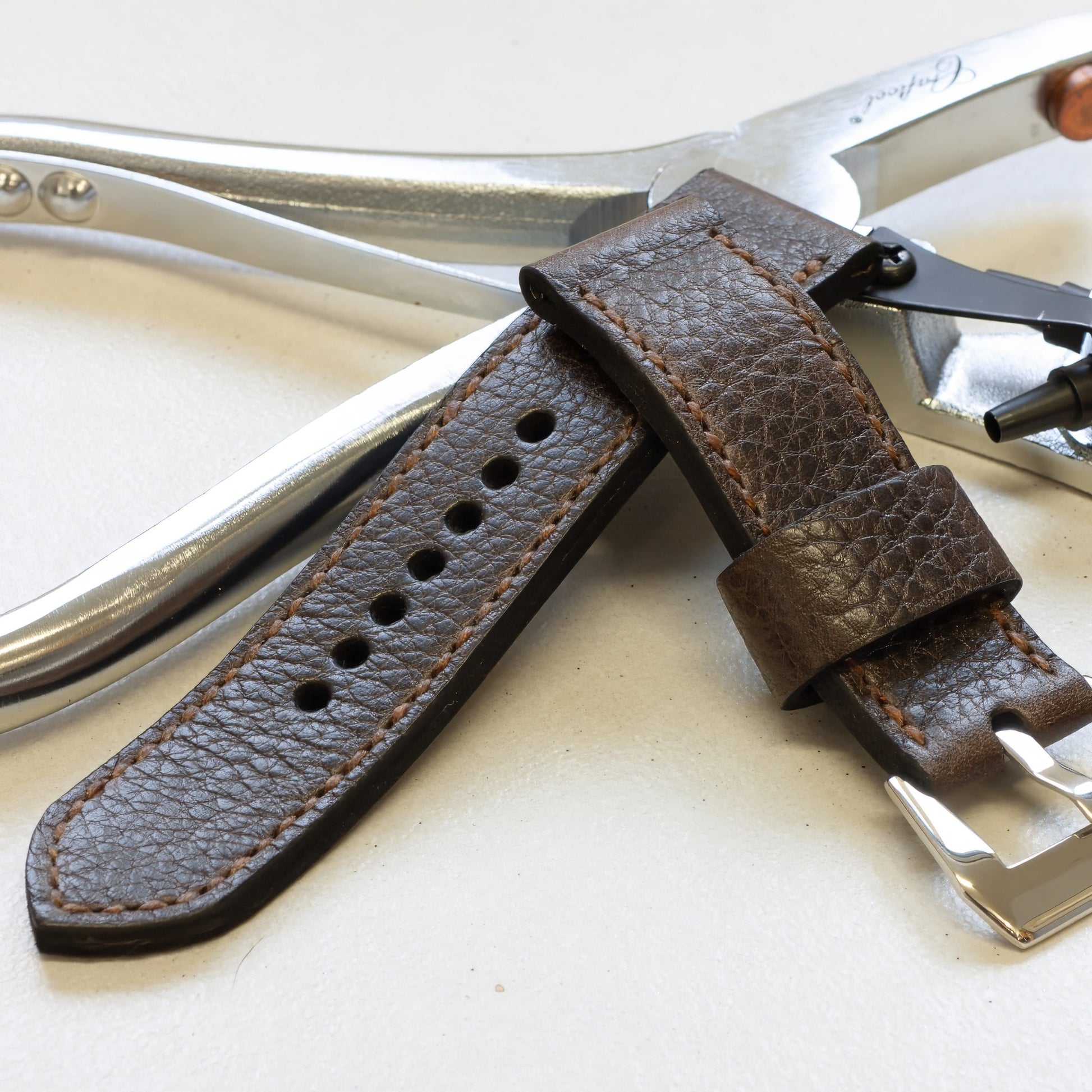 Nordic Ox leather watch strap with light brown stitching and polished steel buckle