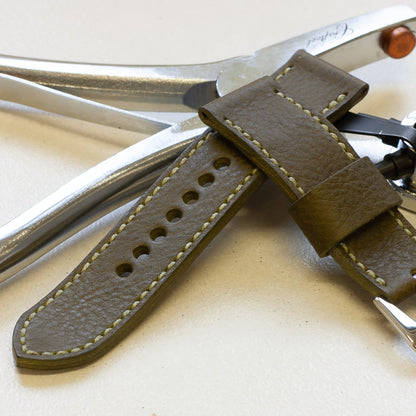Oliva leather watch strap with olive drab stitching and polished steel buckle