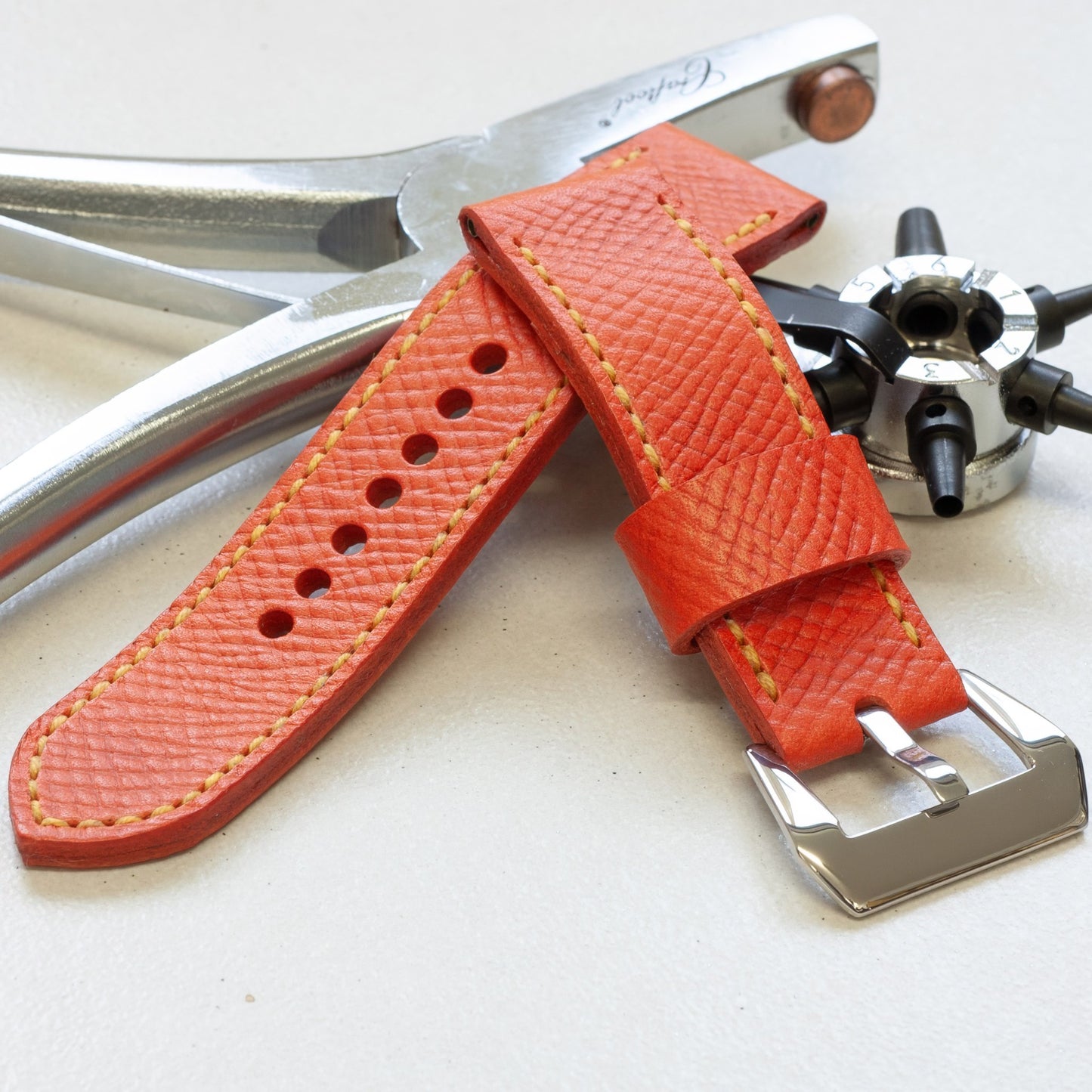 Orange Crush leather watch strap with bright yellow stitching and polished steel buckle