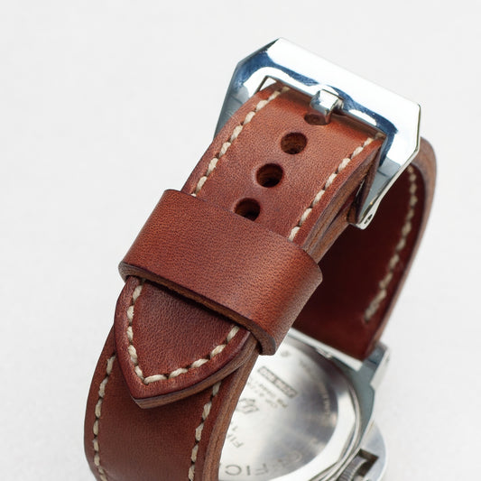 Papaya leather watch strap with natural stitching and polished steel buckle