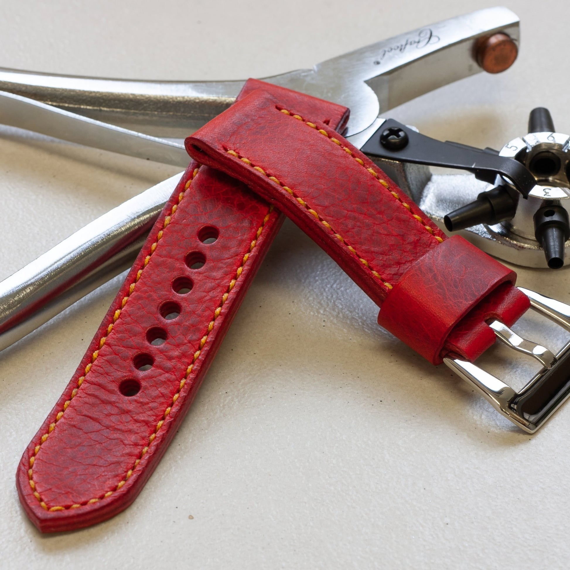 Phoenix leather watch strap with bright yellow stitching and polished steel buckle