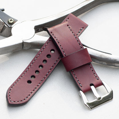 Plum leather watch strap with grey stitching and polished steel buckle
