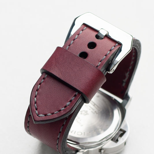 Plum leather watch strap with grey stitching and polished steel buckle
