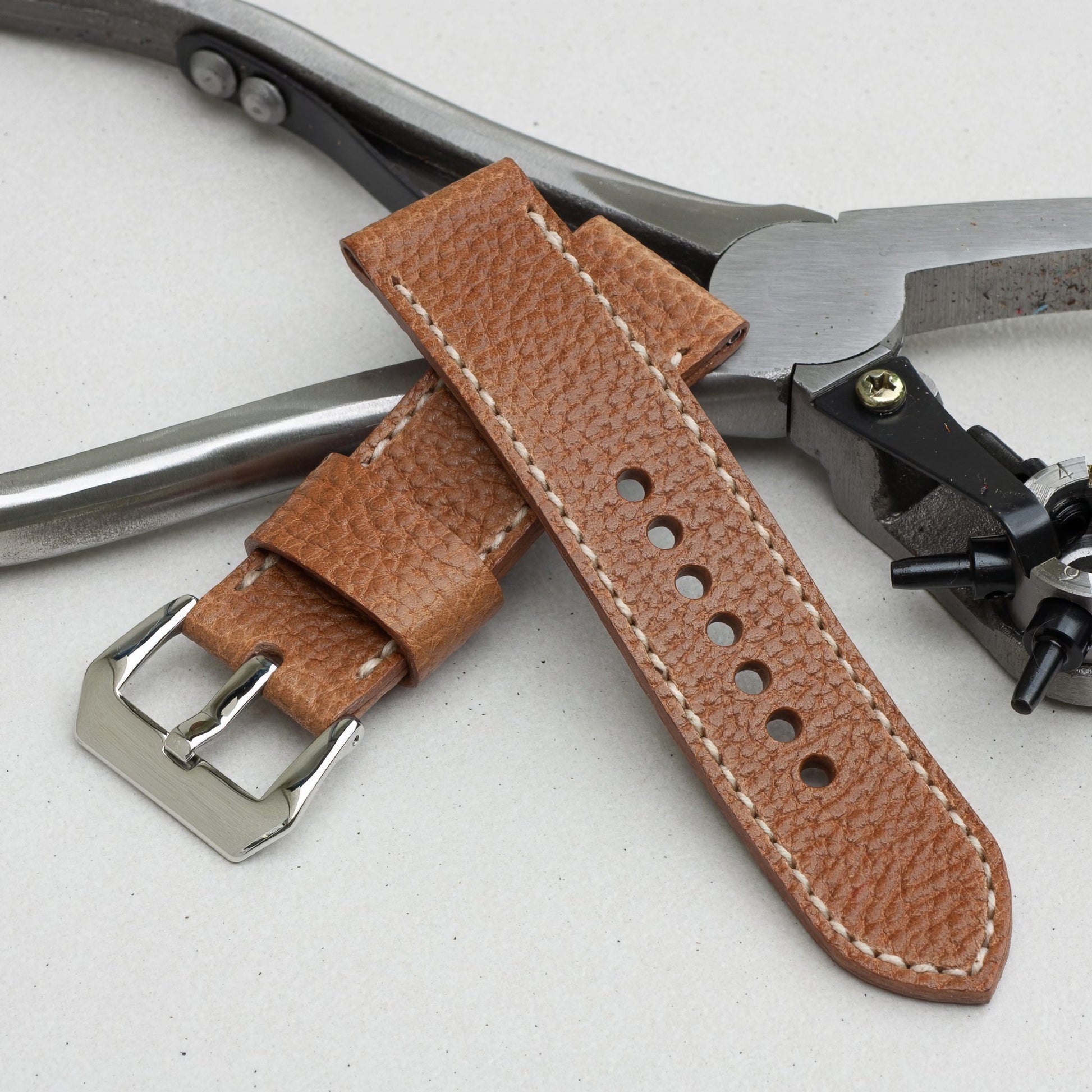 Sandstone leather watch strap with natural stitching and polished steel buckle