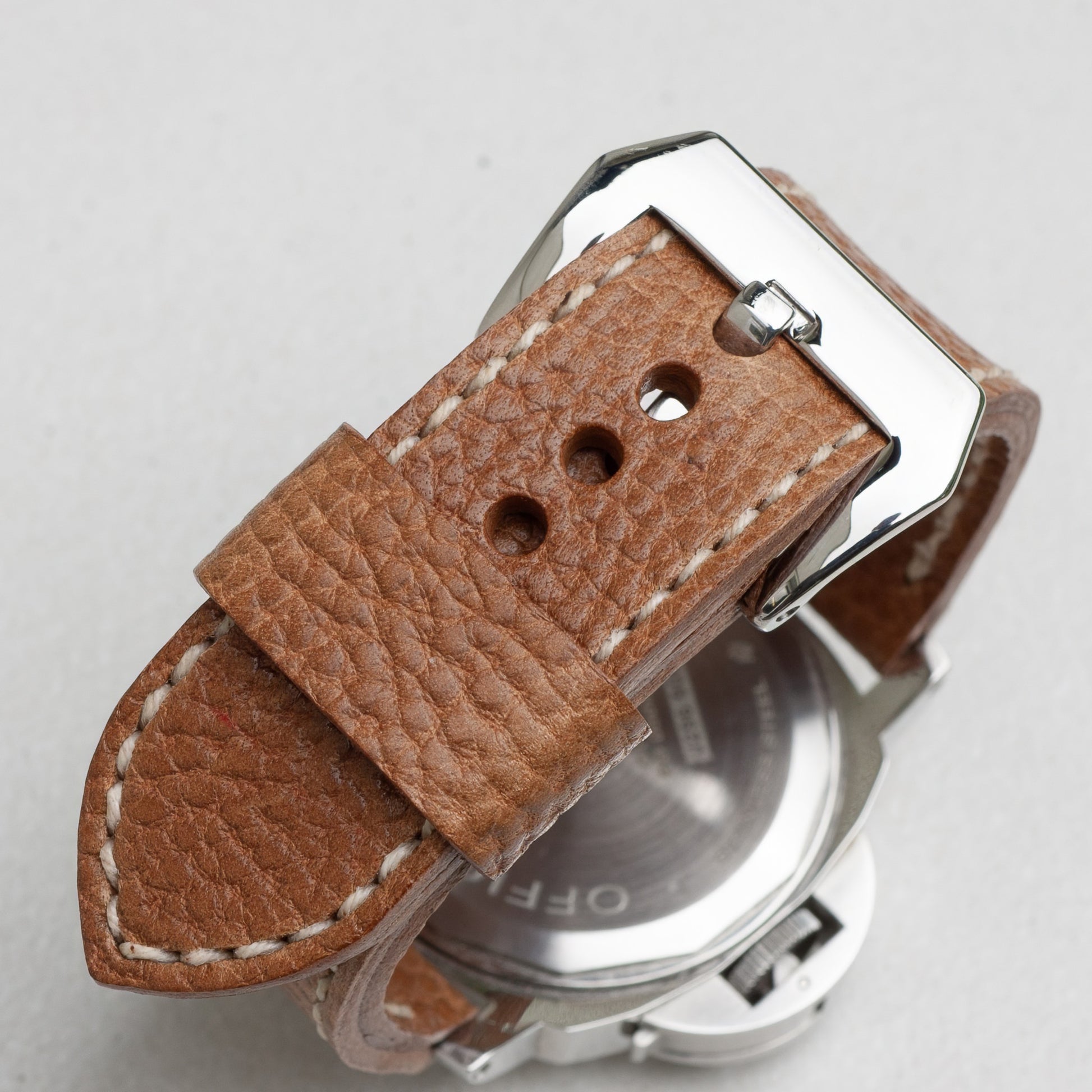 Sandstone leather watch strap with natural stitching and polished steel buckle