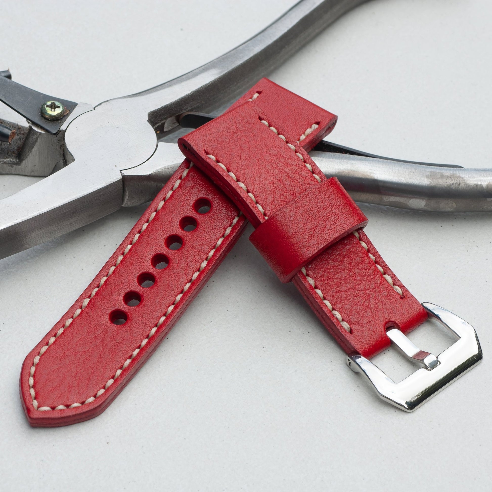 Scarlet leather watch strap with natural stitching and polished steel buckle
