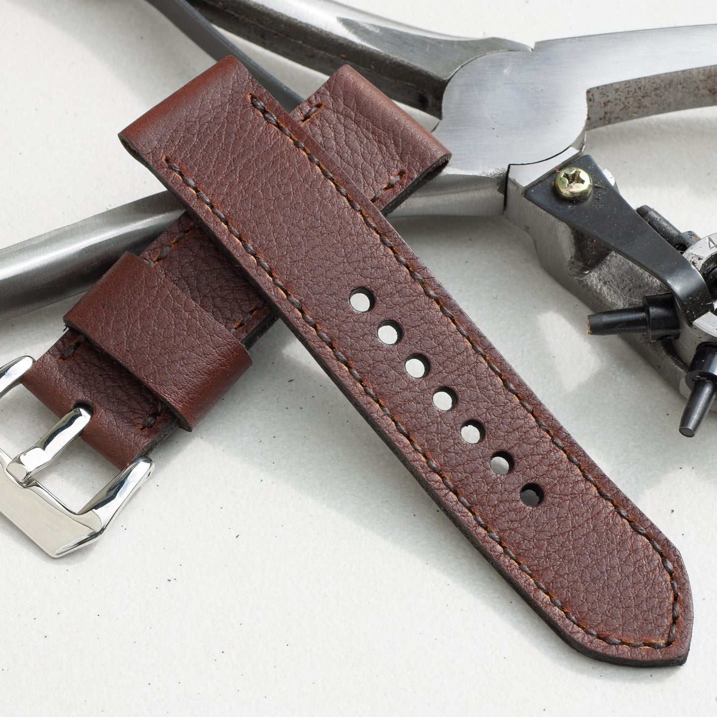 Shooting Brake leather watch strap with dark brown stitching and polished steel buckle