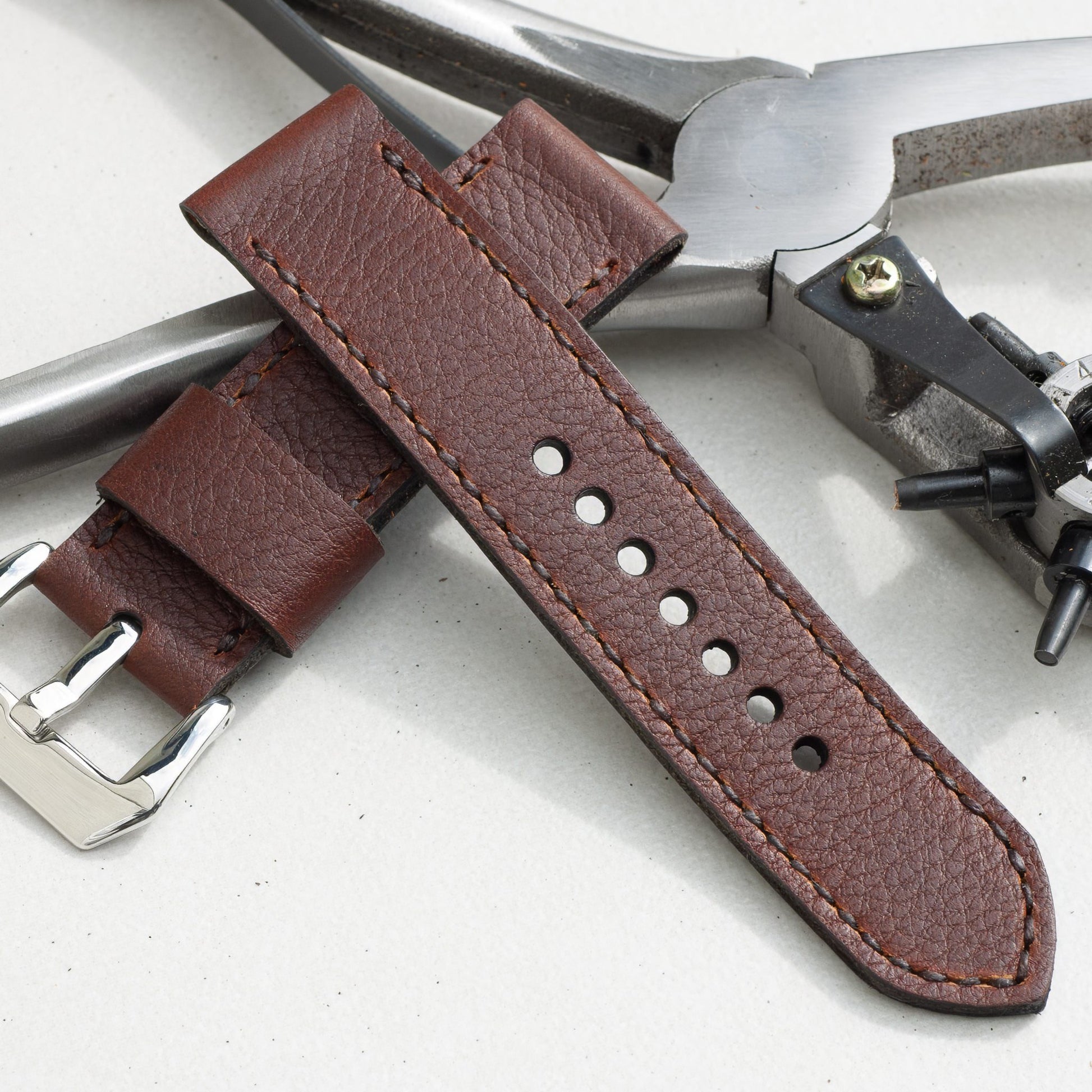 Shooting Brake leather watch strap with dark brown stitching and polished steel buckle