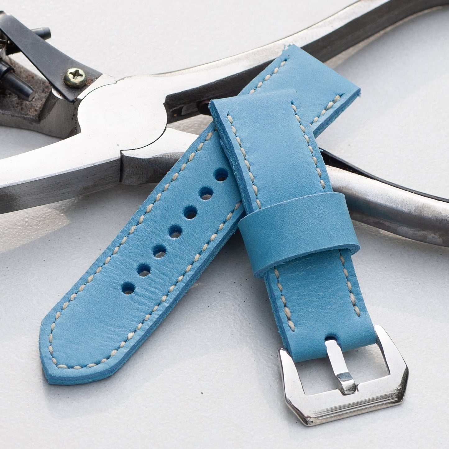 Sky Blue leather watch strap with white stitching and polished steel buckle