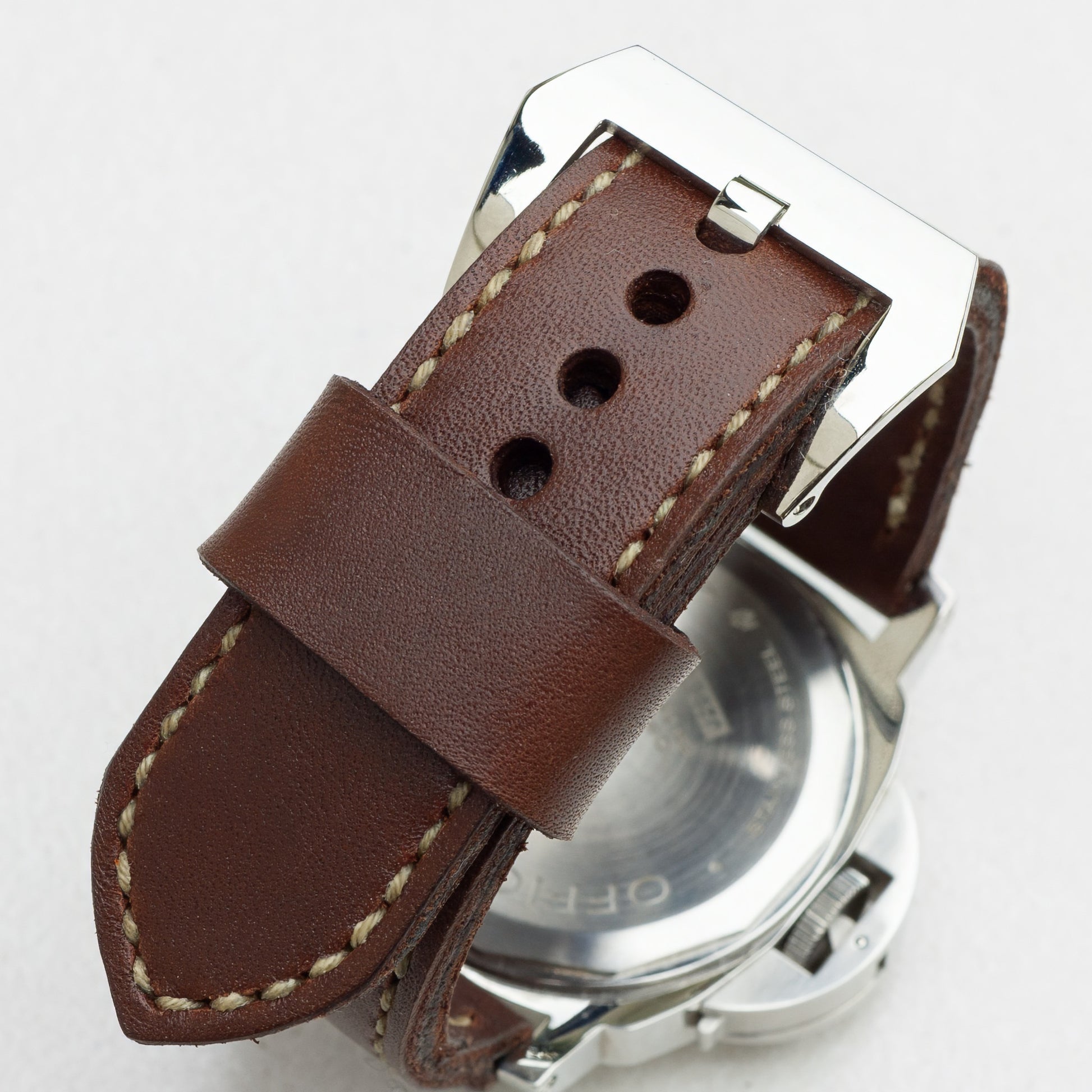 Tobacco leather watch strap with olive drab stitching and polished steel buckle