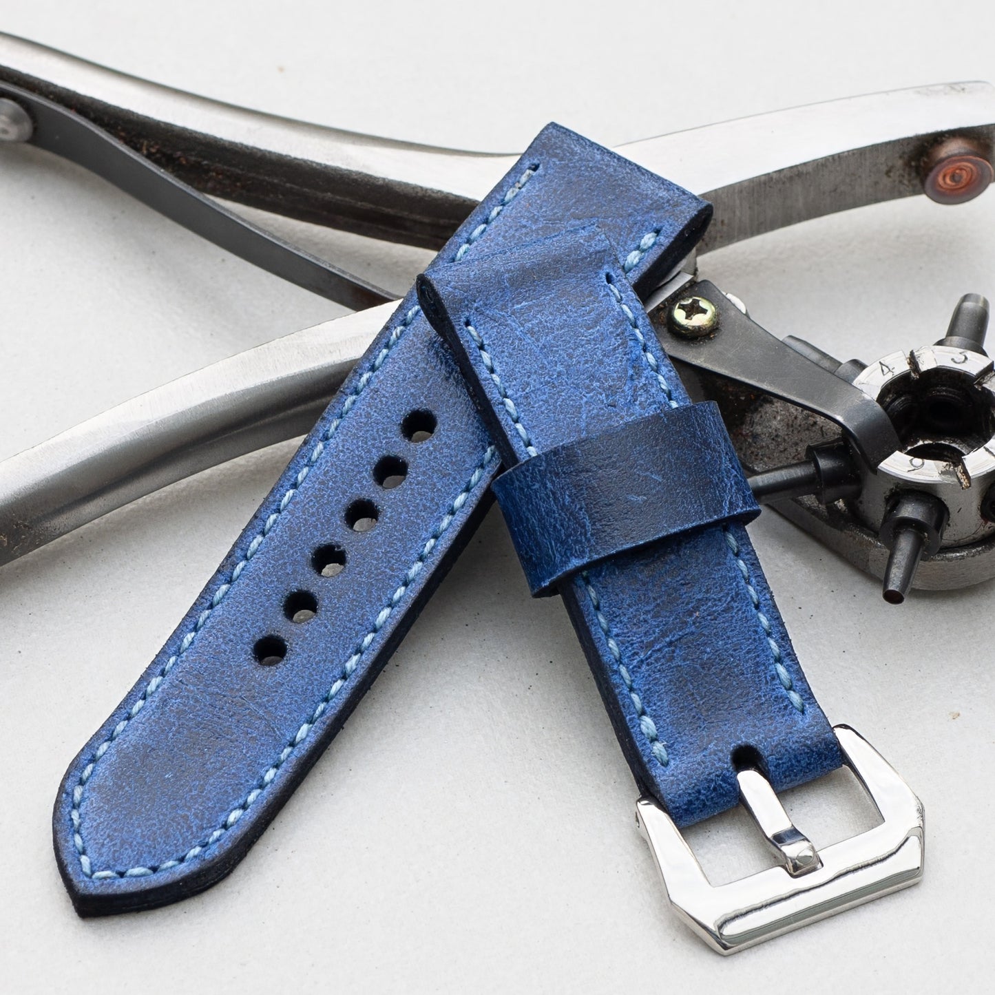Trident leather watch strap with pale blue stitching and polished steel buckle
