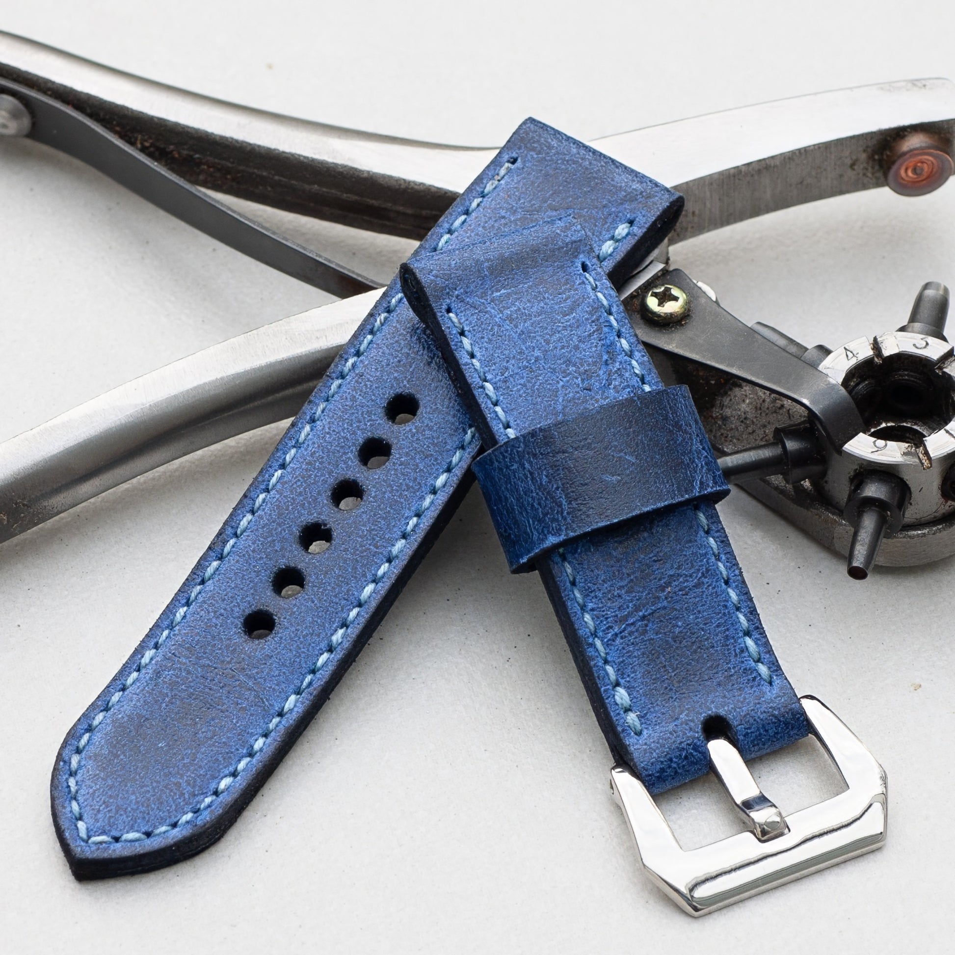 Trident leather watch strap with pale blue stitching and polished steel buckle