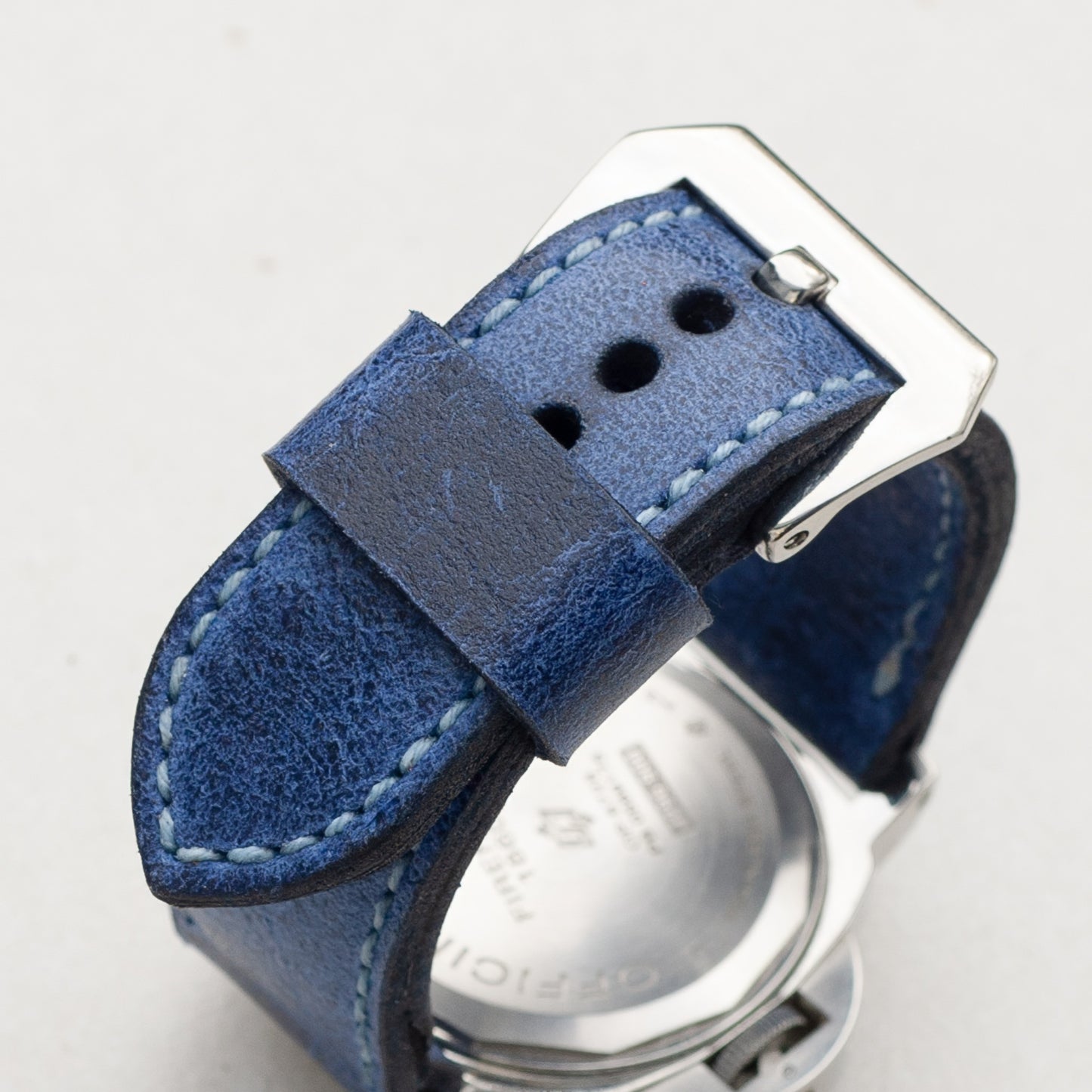 Trident leather watch strap with pale blue stitching and polished steel buckle