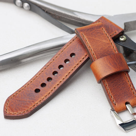Tundra leather watch strap with light brown stitching and polished steel buckle