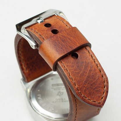 Tundra leather watch strap with light brown stitching and polished steel buckle
