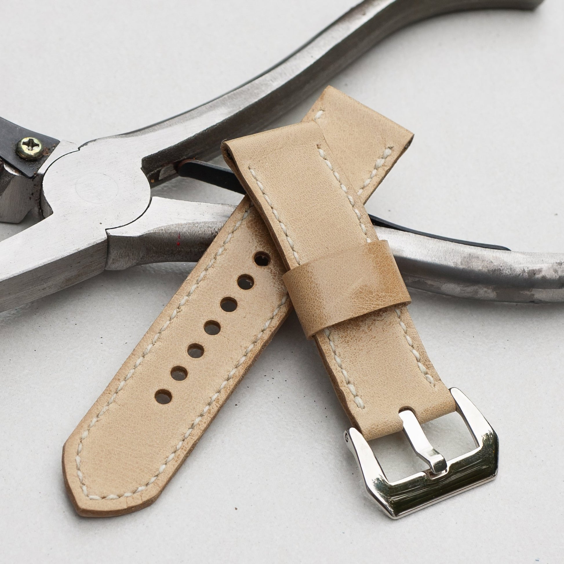 Vanilla leather watch strap with white stitching and polished steel buckle