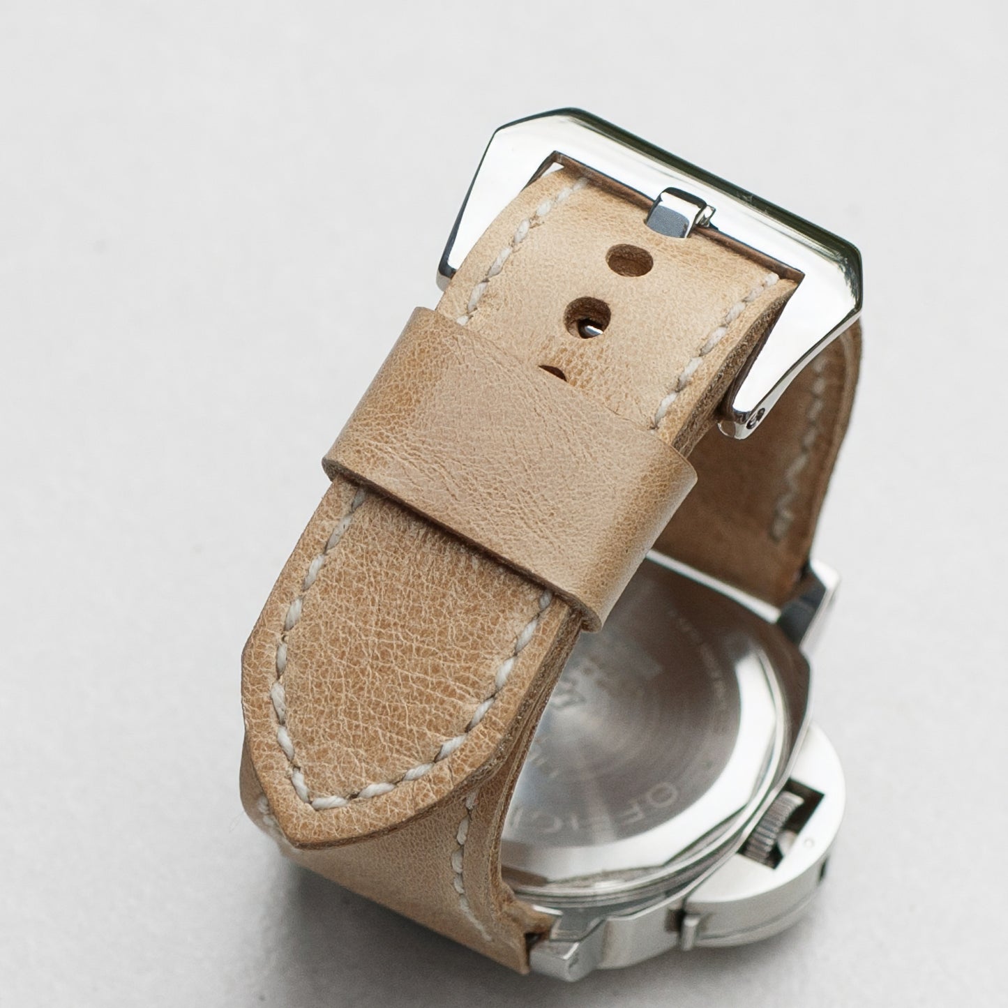 Vanilla leather watch strap with white stitching and polished steel buckle