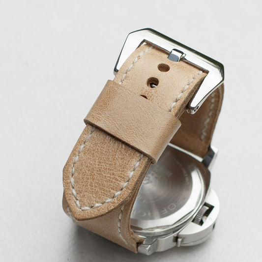 Vanilla leather watch strap with white stitching and polished steel buckle