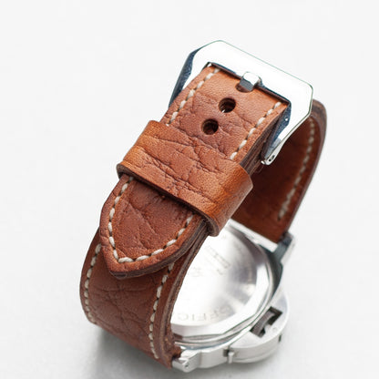 Walnut leather watch strap with natural stitching and polished steel buckle